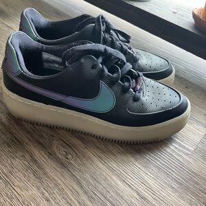 Nike Air Force Ones. Black with an iridescent swoosh. Size 9 lightly worn.